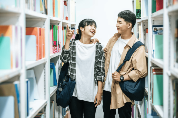 men-women-carrying-backpack-searching-books-library_1150-24656